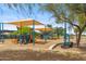 Community playground offers covered play equipment and seating area at 15252 N 100Th St # 1172, Scottsdale, AZ 85260