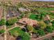 Aerial view showing the home's roof line, community amenities, parking, and beautiful landscaping at 15416 W Valentine St, Surprise, AZ 85379