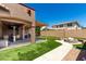 Beautiful backyard with artificial grass, fire pit, and covered patio, great for outdoor living at 15416 W Valentine St, Surprise, AZ 85379