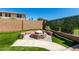 Beautiful backyard featuring a charming stone fire pit and well-maintained artificial grass, perfect for outdoor gatherings at 15416 W Valentine St, Surprise, AZ 85379
