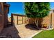 Private backyard with a storage shed, rock landscaping, and a mature shade tree at 15416 W Valentine St, Surprise, AZ 85379