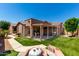 Expansive backyard features artificial turf, a fire pit, and covered patio ideal for entertaining at 15416 W Valentine St, Surprise, AZ 85379