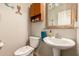 This quirky half-bathroom features a pedestal sink, mermaid-themed decor, and a charming toilet seat at 15416 W Valentine St, Surprise, AZ 85379