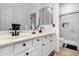 Stylish bathroom boasts double sinks, black fixtures, and a tiled shower with built-in niche at 15416 W Valentine St, Surprise, AZ 85379