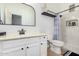 Well-lit bathroom features a stylish vanity, toilet and shower with tiled surround and built-in niche at 15416 W Valentine St, Surprise, AZ 85379