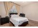 Cozy bedroom with neutral walls features window with curtains, comfortable bed and an office space at 15416 W Valentine St, Surprise, AZ 85379