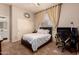 Neutral bedroom features a bed, desk, curtains, closet and ceiling fan providing a serene, comfortable space at 15416 W Valentine St, Surprise, AZ 85379