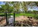Charming community park with gazebo, bridge, and playground equipment in a green space at 15416 W Valentine St, Surprise, AZ 85379