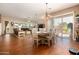 Open floor plan with dining area adjacent to the living room and sliding glass doors at 15416 W Valentine St, Surprise, AZ 85379