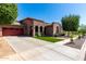 Exterior shot featuring a well-kept lawn, beautiful landscaping and charming architecture at 15416 W Valentine St, Surprise, AZ 85379