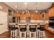 Well-lit kitchen with granite countertops, stainless steel appliances, and breakfast bar seating at 15416 W Valentine St, Surprise, AZ 85379