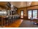 Clubhouse kitchen featuring a large island, bar stools, stainless steel appliances, and hardwood floors at 15416 W Valentine St, Surprise, AZ 85379
