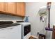 Well-equipped laundry room with modern appliances, cabinets, and a convenient layout at 15416 W Valentine St, Surprise, AZ 85379