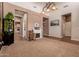 Bright living area featuring neutral paint colors, an electric fireplace, and an elegant chandelier at 15416 W Valentine St, Surprise, AZ 85379