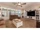 This bright and airy living room is complete with a ceiling fan, plush carpet, large windows, and comfortable seating at 15416 W Valentine St, Surprise, AZ 85379