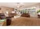 This spacious living room boasts plush carpet, comfortable furniture, and plenty of natural light from the many windows at 15416 W Valentine St, Surprise, AZ 85379