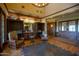 Clubhouse lobby featuring wood floors, comfortable seating, built-in bookshelves, and a chandelier at 15416 W Valentine St, Surprise, AZ 85379