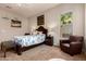 This cozy main bedroom offers plush carpet, ample natural light, a ceiling fan, and warm, inviting decor at 15416 W Valentine St, Surprise, AZ 85379