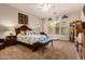 This bright main bedroom features a decorative headboard, bench, plush carpet, and three large windows at 15416 W Valentine St, Surprise, AZ 85379