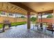 Covered patio, outdoor seating, grill, and a well-maintained yard perfect for entertaining at 15416 W Valentine St, Surprise, AZ 85379
