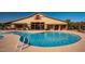 Inviting community pool with spacious deck, seating areas, and convenient restroom facilities at 15416 W Valentine St, Surprise, AZ 85379