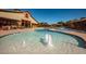 Beautiful community pool area with fountains and plenty of lounge chairs for residents to enjoy at 15416 W Valentine St, Surprise, AZ 85379
