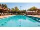 Community pool with shaded lounge areas and clear blue water for swimming and recreation at 15416 W Valentine St, Surprise, AZ 85379