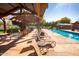 Enjoy poolside relaxation with comfortable lounge chairs and shaded seating areas at 15416 W Valentine St, Surprise, AZ 85379