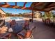 Inviting poolside patio area with comfortable seating and shade for relaxing and entertaining at 15416 W Valentine St, Surprise, AZ 85379