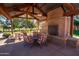 Outdoor recreation area with a brick fireplace, comfortable seating, and picnic tables at 15416 W Valentine St, Surprise, AZ 85379