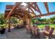Outdoor recreation area featuring a brick fireplace, seating area, and picnic tables at 15416 W Valentine St, Surprise, AZ 85379