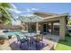 Inviting backyard with pool, patio seating, and lush landscaping perfect for outdoor entertaining at 15848 W Calavar Rd, Surprise, AZ 85379