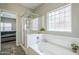 Bright, modern bathroom featuring separate shower and bathtub at 15848 W Calavar Rd, Surprise, AZ 85379