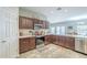 Spacious kitchen featuring granite countertops, stainless steel appliances, and dark wood cabinets at 15848 W Calavar Rd, Surprise, AZ 85379