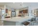 Open kitchen with a breakfast bar, stainless steel appliances, and dark wood cabinets at 15848 W Calavar Rd, Surprise, AZ 85379
