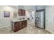 Kitchen with a breakfast bar, stainless steel refrigerator, and dark wood cabinets at 15848 W Calavar Rd, Surprise, AZ 85379