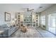 Comfortable living room with large decorative shelving and gray couch at 15848 W Calavar Rd, Surprise, AZ 85379