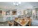 Bright, open-concept living space with dining area and modern kitchen at 15848 W Calavar Rd, Surprise, AZ 85379