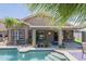 Beautiful backyard featuring a refreshing pool with a covered patio and well-maintained landscaping at 15848 W Calavar Rd, Surprise, AZ 85379