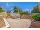 Backyard with brick patio, garden, stucco walls and decorative metal gate leading to the pool at 1618 W Vernon Ave, Phoenix, AZ 85007
