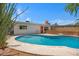 Inviting backyard pool featuring a spacious patio area, well-maintained landscaping, and an outdoor dining area at 1618 W Vernon Ave, Phoenix, AZ 85007