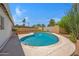 Backyard pool featuring lush landscaping, patio area, and privacy fencing with views of palm trees at 1618 W Vernon Ave, Phoenix, AZ 85007