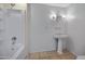 Clean bathroom offers a tub-shower combination, a pedestal sink, modern lighting, and tile flooring at 1618 W Vernon Ave, Phoenix, AZ 85007