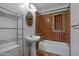 Charming bathroom featuring decorative tile work in the shower, pedestal sink, and convenient shelving at 1618 W Vernon Ave, Phoenix, AZ 85007