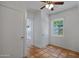 Bedroom showcasing tile flooring, white walls, ceiling fan, natural light, and doorway views to other rooms at 1618 W Vernon Ave, Phoenix, AZ 85007