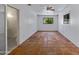 Spacious bedroom boasts tile floors, white walls, bright windows, and an ensuite bathroom for convenience at 1618 W Vernon Ave, Phoenix, AZ 85007