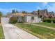 Charming single-story home with a long driveway and lush green lawn at 1618 W Vernon Ave, Phoenix, AZ 85007