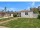 Charming single-story home with a brick pathway, lush lawn, and vibrant landscaping at 1618 W Vernon Ave, Phoenix, AZ 85007