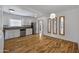 Open kitchen with stainless steel appliances, white cabinets, and wood-look flooring at 1618 W Vernon Ave, Phoenix, AZ 85007