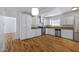 Bright kitchen with white cabinets, stainless steel appliances, and wood-look flooring at 1618 W Vernon Ave, Phoenix, AZ 85007